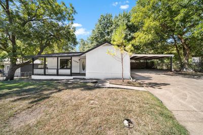 View of front of property featuring a carport, covered porch, and a front yard | Image 2