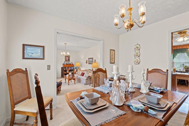 Dining space with a textured ceiling and a notable chandelier | Image 11