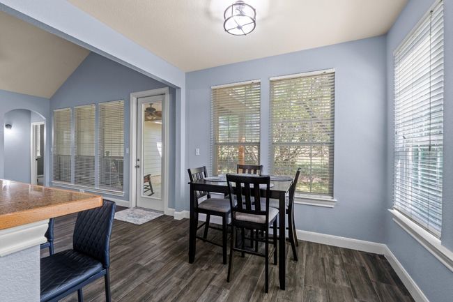 Dining room featuring a healthy amount of sunlight, arched walkways, and dark wood-style floors | Image 17
