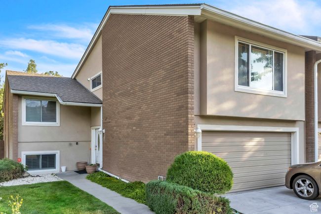 View of front of home with stucco siding and brick siding | Image 4