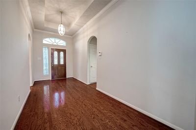 Architectural details include a tray ceiling with chandelier, arched walkways and crown molding! | Image 3