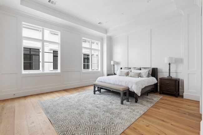 The luxurious master bedroom boasts soaring 12' tray ceiling with elegant floor to ceiling paneling. | Image 20