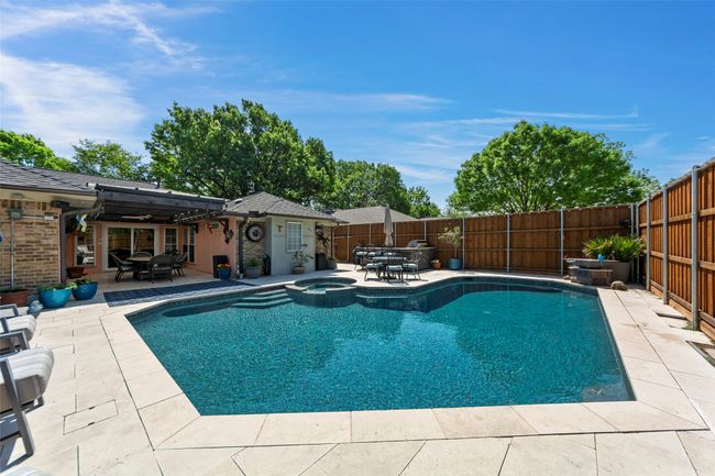 View of pool with outdoor dining space, a patio, and a fenced backyard | Image 5