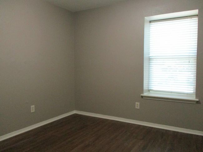Bedroom 3 featuring dark wood look vinyl plank flooring | Image 11