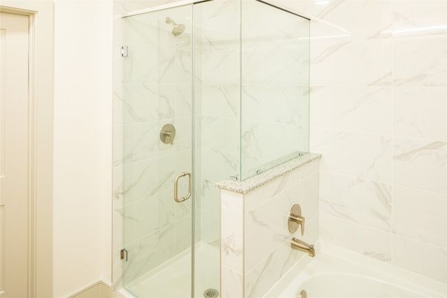 Bathroom featuring enclosed tub / shower combo | Image 7