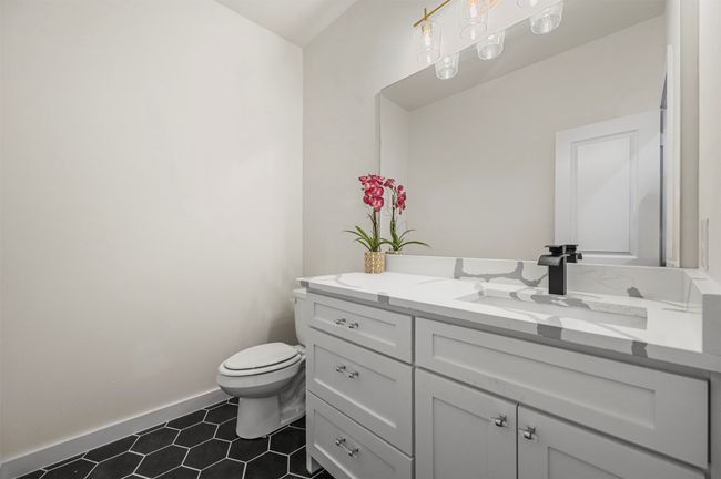Bathroom featuring toilet, tile patterned floors, vanity, and baseboards | Image 23