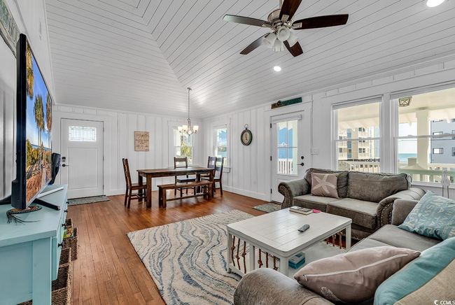 Living room with lofted ceiling, plenty of natural light, wood-type flooring, and wooden ceiling | Image 9