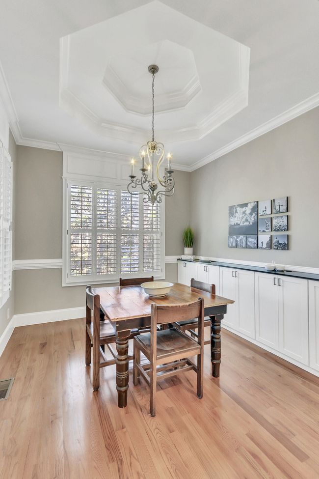 The home has tall ceilings and five inch wood shutters on the windows throughout! Note the custom detail in the ceiling. | Image 22
