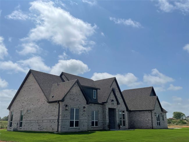 View of front facade featuring brick siding, a front lawn, and a shingled roof | Image 4
