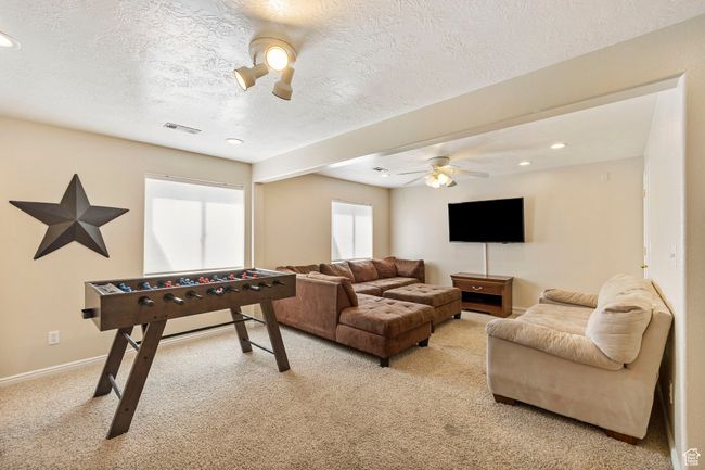 Game room featuring recessed lighting, visible vents, light carpet, a textured ceiling, and ceiling fan | Image 28