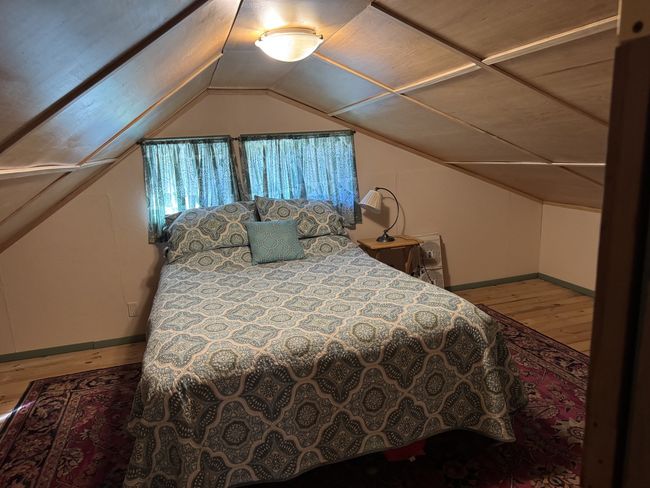 Bedroom with wood finished floors and lofted ceiling | Image 5