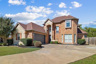 View of property featuring a front lawn and a garage | Image 2