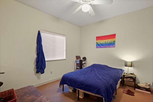 Carpeted bedroom featuring a ceiling fan | Image 10