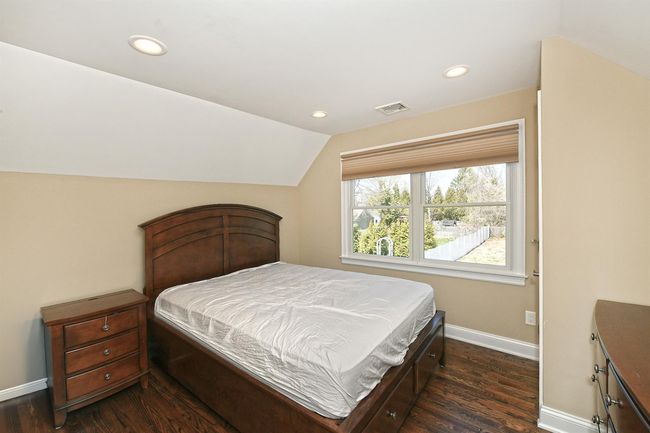 Bedroom featuring baseboards, vaulted ceiling, visible vents, and recessed lighting | Image 29