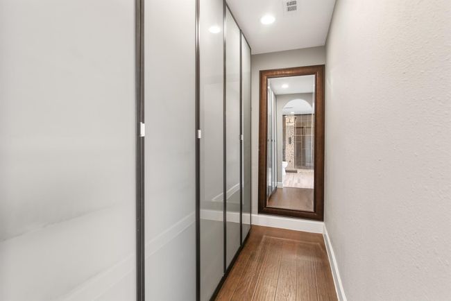 The spacious primary closet has custom built ins perfect for all your storage needs. | Image 20