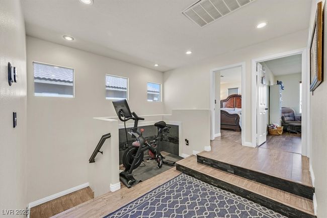 Exercise area with recessed lighting, wood finished floors, and visible vents | Image 15