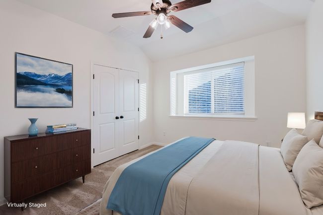 Upstairs Bedroom 2, a closet, lofted ceiling, light colored carpet, and ceiling fan | Image 26
