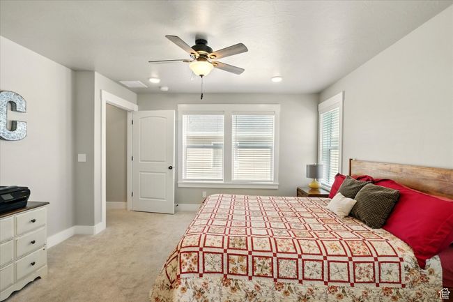 Bedroom with light colored carpet and ceiling fan | Image 8