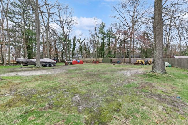 View of yard with an outdoor structure, fence, and a storage unit | Image 29