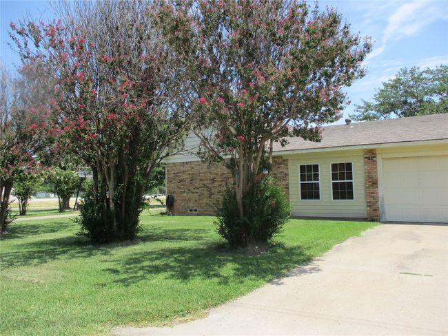 View of front of home with a garage and a front lawn | Image 5