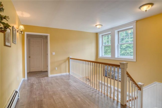 Hall featuring hardwood / wood-style flooring and a baseboard radiator | Image 21