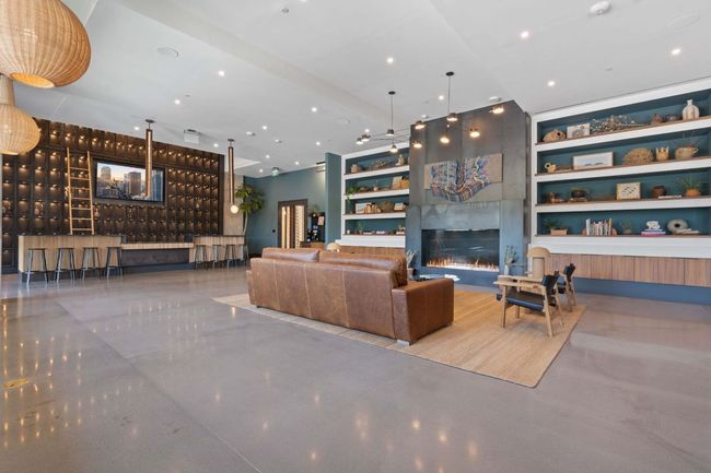 Living room featuring built in shelves and a fireplace | Image 30