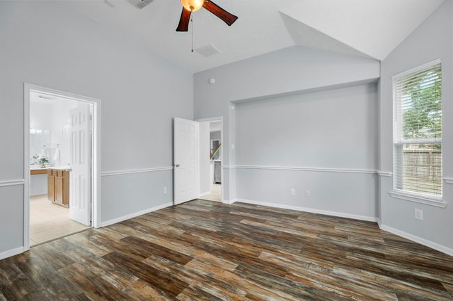 Spacious and tucked away at the back of the home, the primary suite offers a quiet spot to unwind at the end of the day. | Image 18