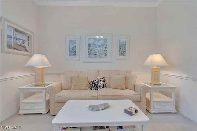Living area with carpet flooring, baseboards, and crown molding | Image 8