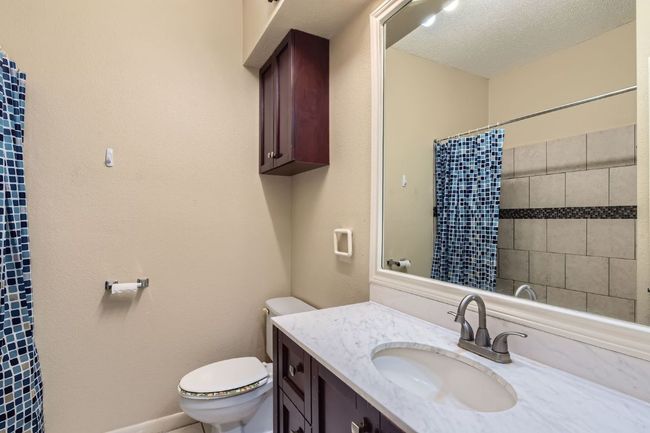 Full bath featuring vanity, toilet, and a shower with shower curtain | Image 21