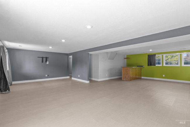Unfurnished living room with bar area, recessed lighting, and light floors | Image 34