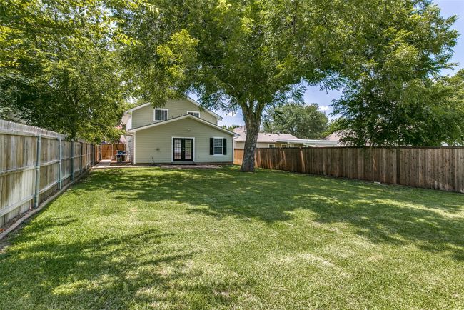 Fenced backyard featuring french doors | Image 25