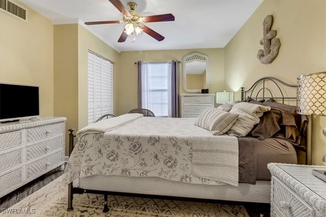 Bedroom featuring a ceiling fan and crown molding | Image 18