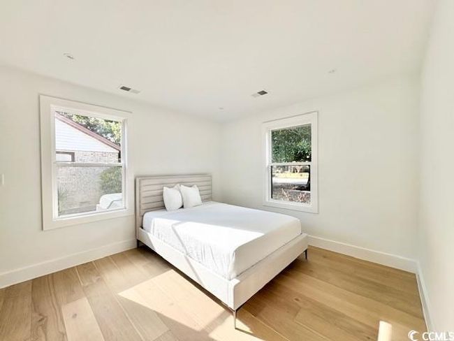 Bedroom with baseboards and light wood finished floors | Image 25
