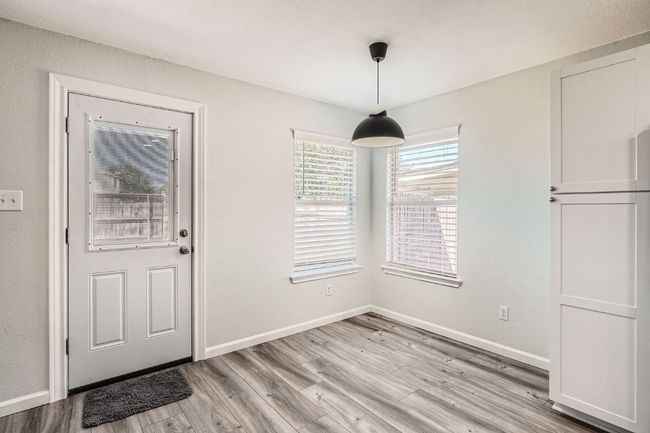 Unfurnished dining area with baseboards and light wood-type flooring | Image 11