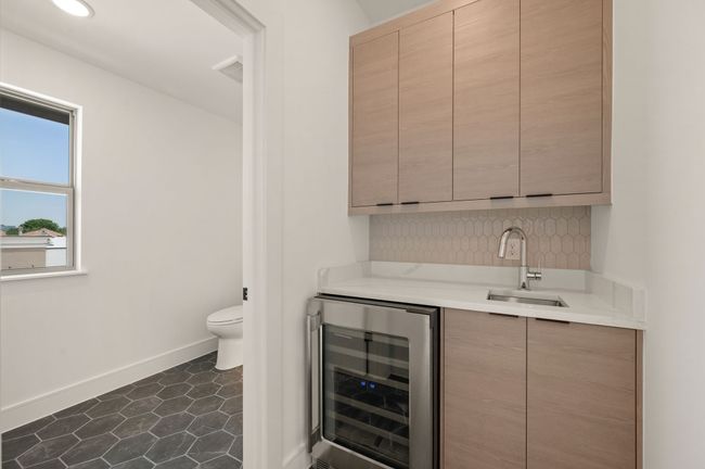 Just off the game room, you'll find a wet bar and half bath for easy entertaining! | Image 18