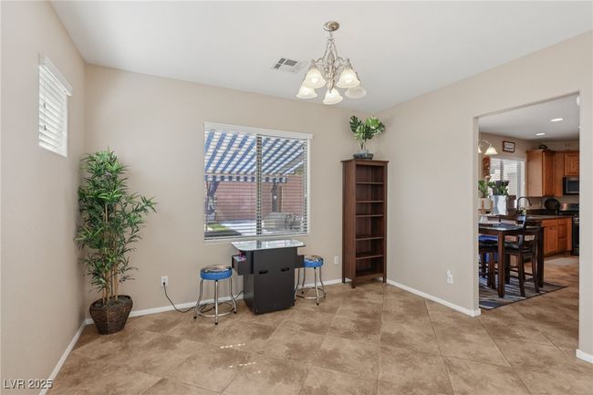 Dining room with a chandelier, plenty of natural light, and baseboards | Image 13