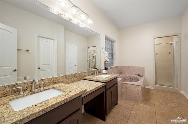 Full bath with double vanity, a garden tub, a shower stall, and tile patterned flooring | Image 10