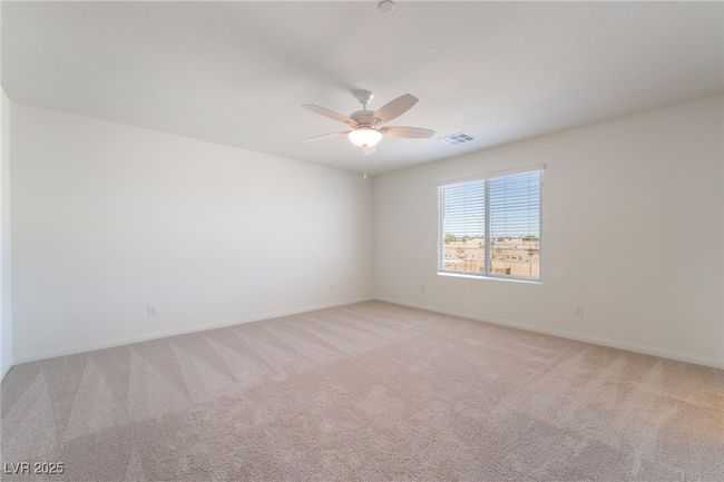 Spare room featuring a ceiling fan and light carpet | Image 19