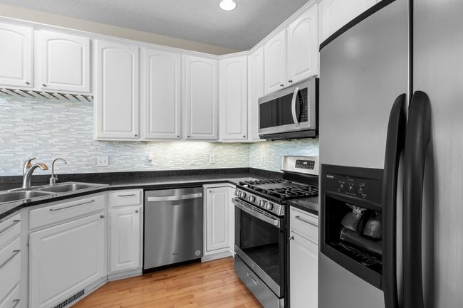 Brand new gas stove and slots for stemware under the cabinet over the sink. | Image 18