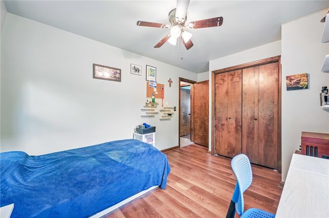 Comfortable bedroom with a study area and views of the outdoors. | Image 36