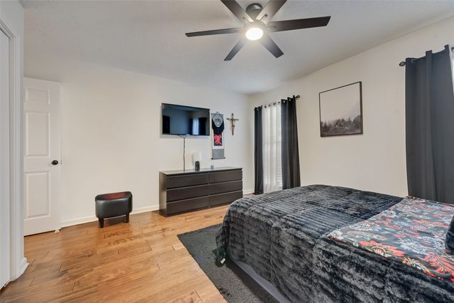 Bedroom featuring wood finished floors and a ceiling fan | Image 12