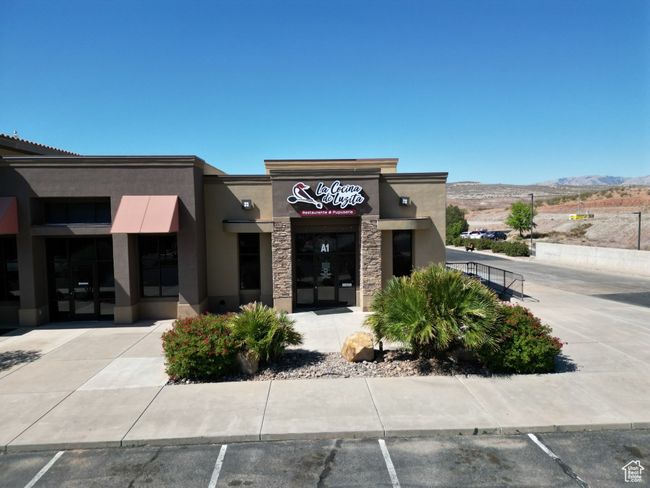 View of property with a mountain view and uncovered parking | Image 4