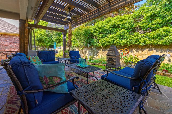 Fenced backyard featuring a pergola, an outdoor hangout area, ceiling fan, perfect for relaxing and entertaining. | Image 28