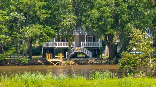 Back of house with stairway, covered porch, and a water view | Image 33