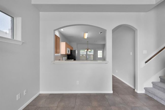 The bar area connects your kitchen to your main living area which sets the stage for lots of entertainment opportunities in the future. The arched features elevate the space and add to that open feel. | Image 9