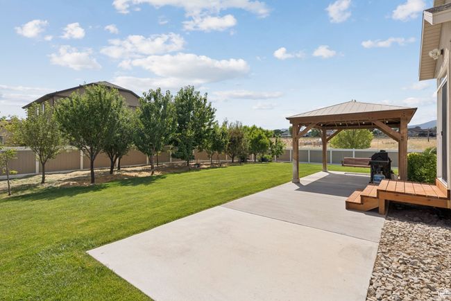 Fenced backyard with a gazebo and a patio area | Image 49