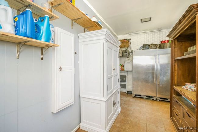 There's an exit from the laundry into the garage. Built-in ironing board | Image 39