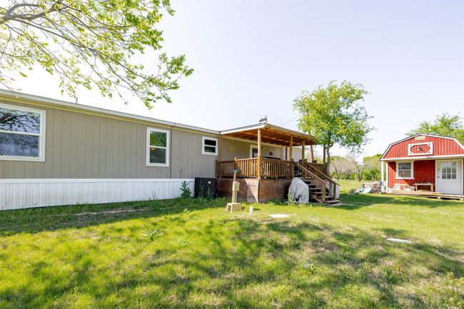 View of yard with an outbuilding, a wooden deck, and central AC unit | Image 26