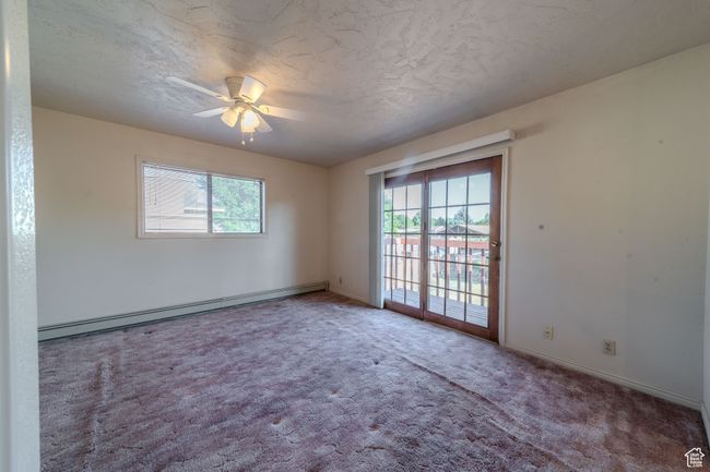 Primary bedroom carpeted with a ceiling fan, and baseboards | Image 20