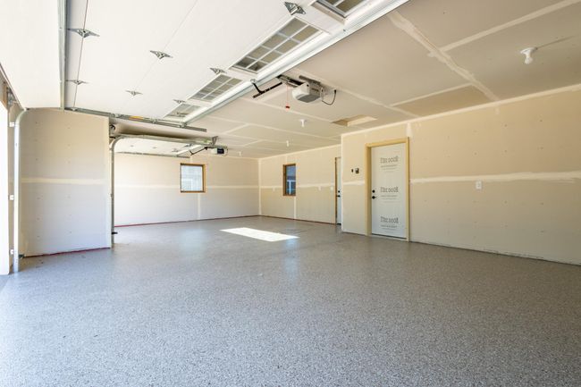 There is a service door to the backyard and a water spigot inside of the garage | Image 18